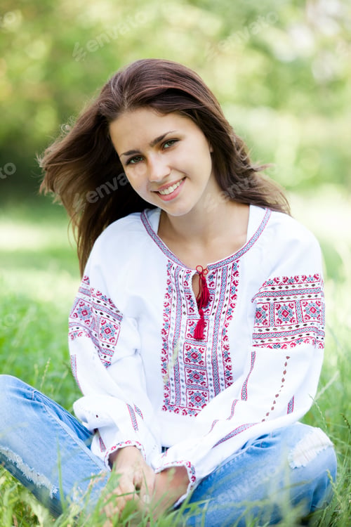 Preview: Slav teen girl at green meadow in national ukrainian clothing.