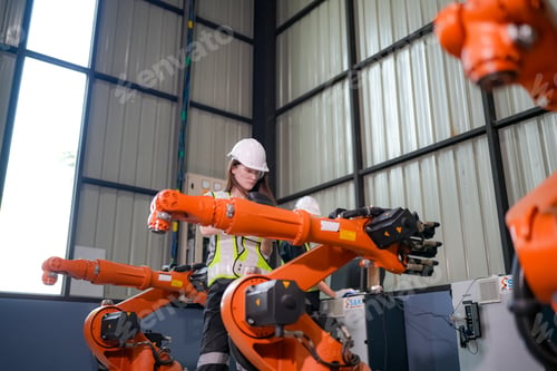 Preview: Engineer testing a robotic production simulator in robotics research facility