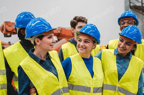 Preview: Multiethnic engineers working together inside automation and robotics facility - New industrial tech