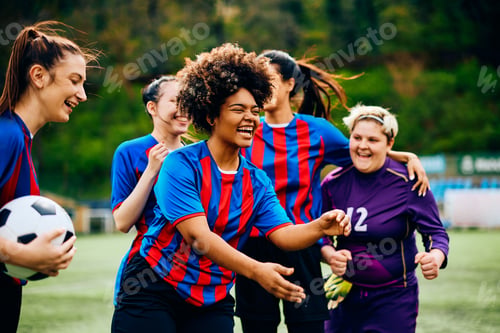 Preview: Cheerful black soccer player and her teammates on playing field.