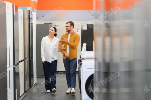 Preview: family couple buying domestic refrigerator in supermarket