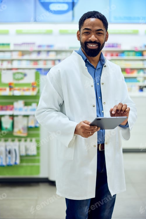 Preview: Smiling Pharmacist Using Digital Tablet in a Modern Pharmacy Environment