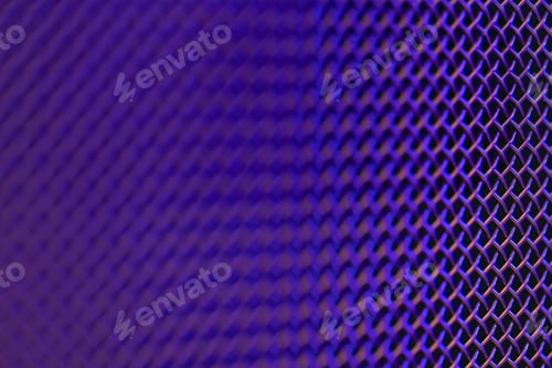 Preview: Metal grill close-up, texture of a music speaker in colored lighting.