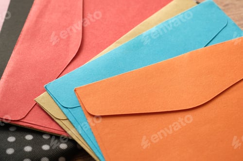 Preview: colorful envelope on wooden background with copy space.