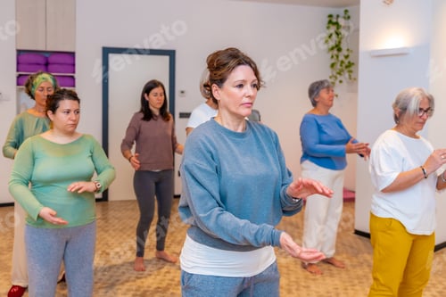 Preview: Women moving coordinated join hands in a qi gong class