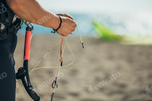 Preview: Woman using flying lines and a control bar for kitesurfing