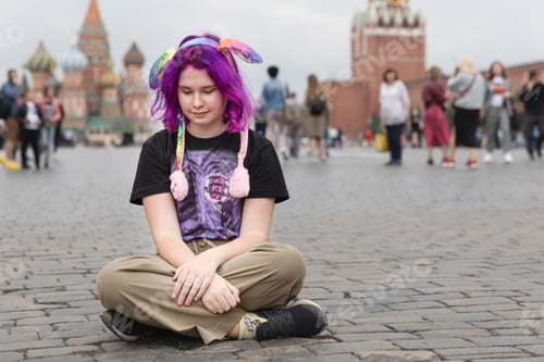 Preview: teen girl with colored pink purple hair on the street