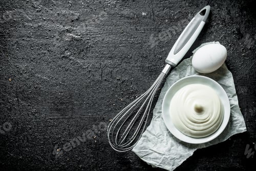 Preview: Mayonnaise in a plate on paper with egg.