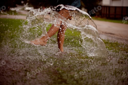 Preview: Splashing the puddles of water on a rainy day