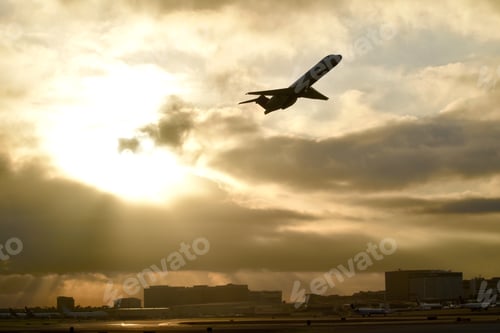 Preview: Plane taking off against a golden sky. Travel industry. Tourism airplanes.