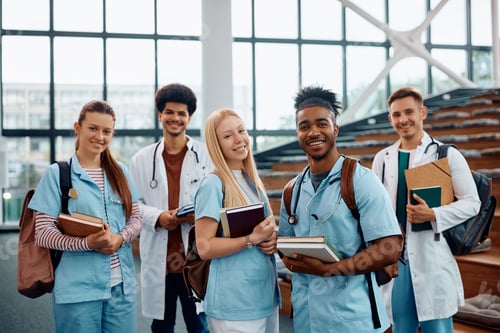 Preview: Group of happy medical and nursing at the university looking at camera.