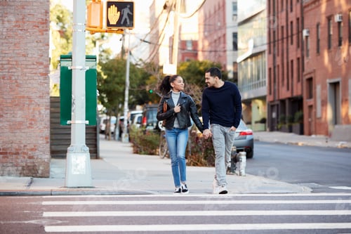 Preview: Young Hispanic couple walk hand in hand in Brooklyn street