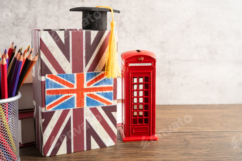 Preview: UK flag with graduate hat on english language book.