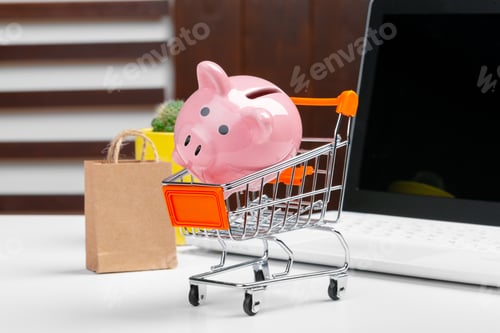 Preview: Online shopping concept. Shopping cart, laptop on the desk