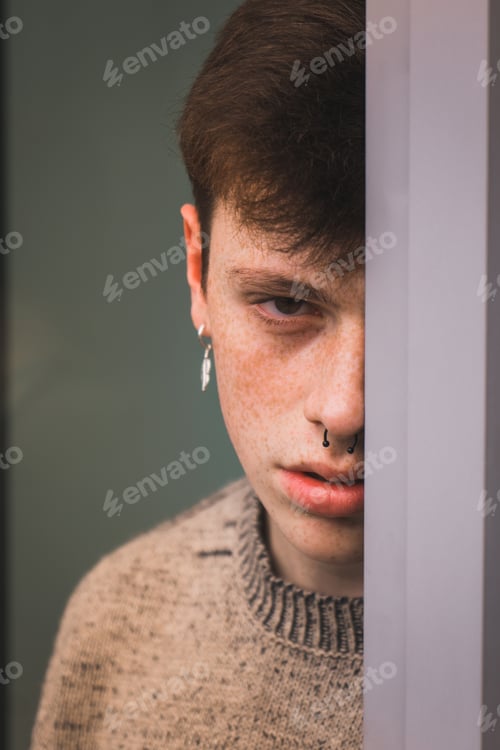 Preview: Sensual young man with freckles leaning on window