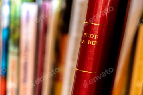 Preview: close up hand search and take the red photo album on the book shelf