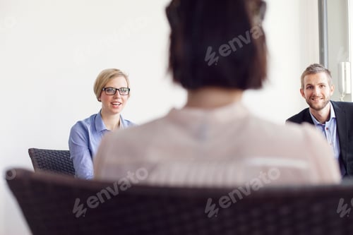 Preview: Smiling creative business people discussing in office