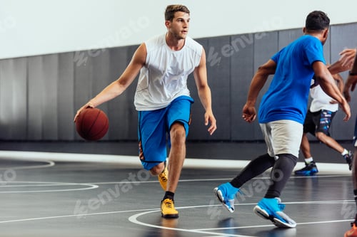 Preview: Male basketball player running with ball in basketball game