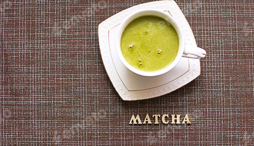 Preview: Japanese matcha green tea is poured into a white mug and on a white saucer in powder
