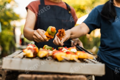 Preview: Skewers with colorful vegetables meat grilling, family friends gathering background, enjoying