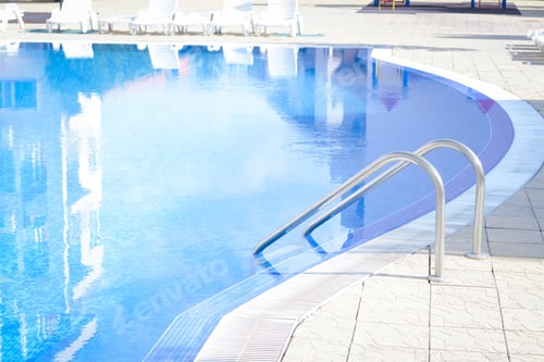 Preview: Outdoor swimming pool with ladder and handrails on sunny day