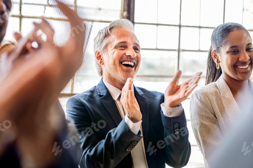 Preview: Team of business people clapping