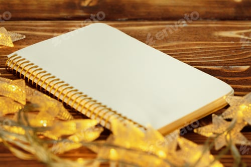 Preview: Blank sheet of paper with golden decorative stars. New year resolutions concept