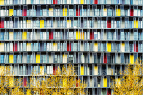 Preview: Breathtaking scenery of a building with colorful doors in the middle of a city during autumn