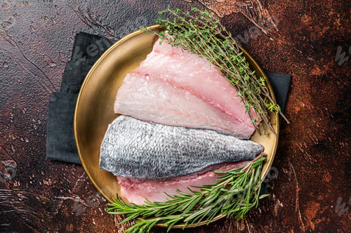 Preview: Fresh Raw Gilthead Sea bream fish fillets ready for cooking. Dark background. Top view