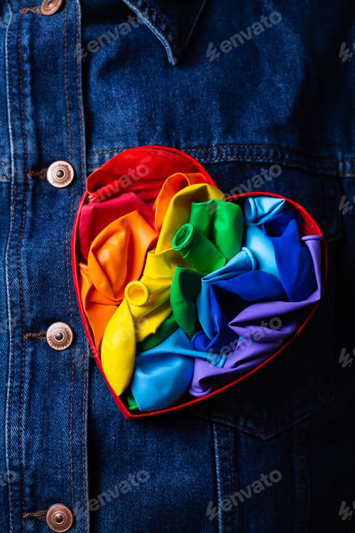 Preview: Heart shaped rainbow lgbtq flag against denim background, pride month