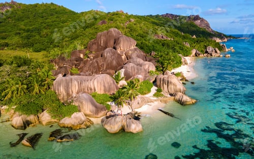 Preview: couple men and woman walking at the beach during sunset at a luxury vacation Seychelles