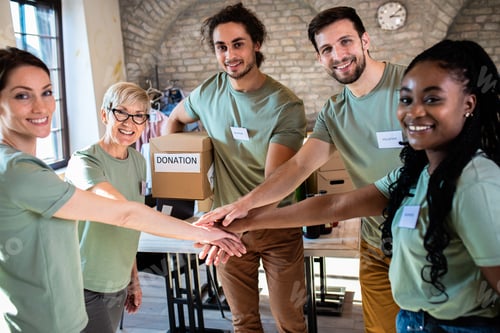 Preview: Portrait of volunteers with working in community charity donation center.