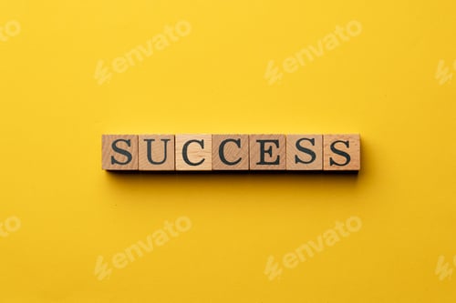Preview: a yellow warm background without shadows wooden cubes with black letters laid out word success