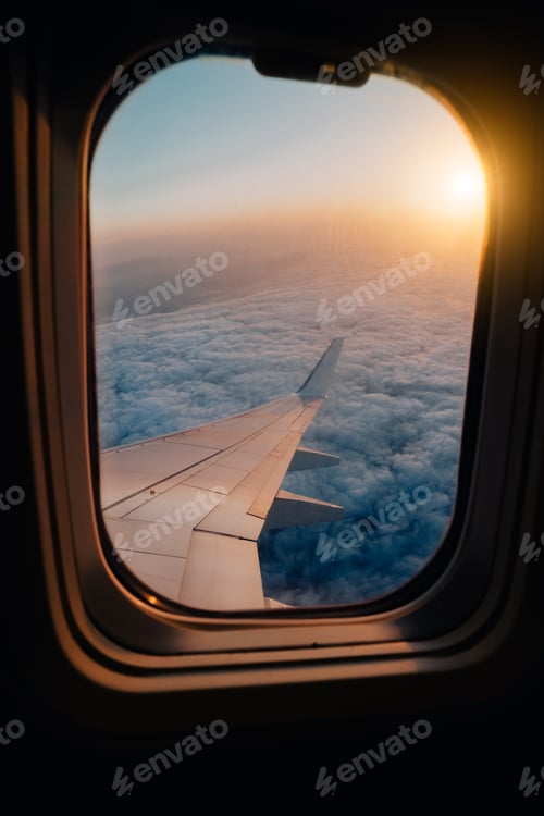 Preview: Evening airplane flight in twilight sky. Sunset view in cabin frozen window frame