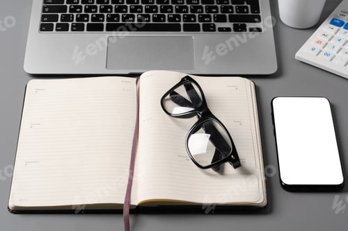 Preview: Notepad is on top of office desk table with laptop and supplies