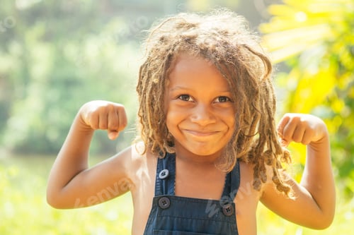 Preview: Mowgli indian boy with dreadlocks hair showing muscle arms in tropics green forest background