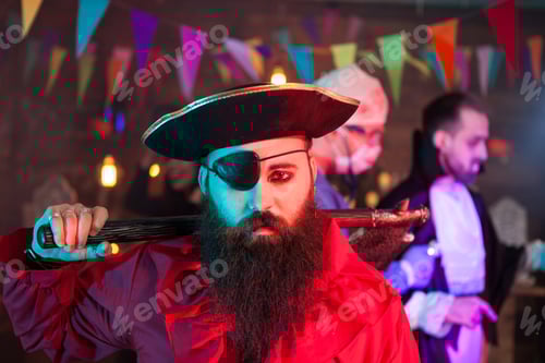 Preview: Portrait of handsome men dressed up like a sad pirate at halloween gathering