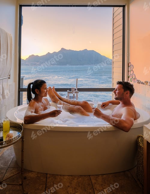 Preview: couple in a bathtub looking out over the ocean of Cape Town South Africa during vacation
