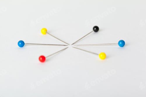 Preview: Colorful pushpins on a white board. School or business concept