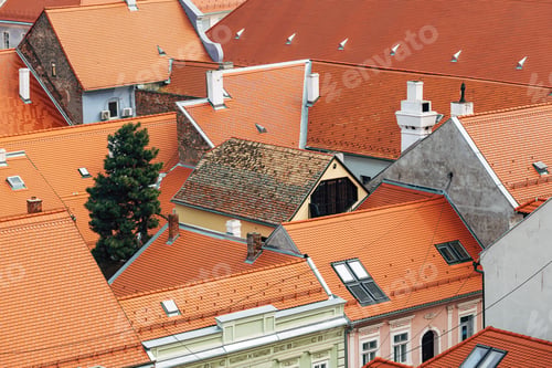 Preview: Weathered roof of old house in picturesque european town with renovated facades and new roof tiles