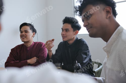 Preview: Diverse Happy Muslim Friends Having Iftar Dinner Together on Ramadan Feast at Dining Table