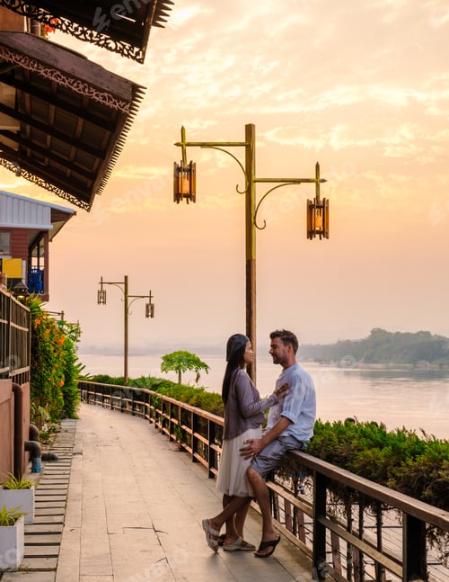 Preview: A couple visit Chiang Khan village North Eastern Thailand alongside the Mekong river at sunset