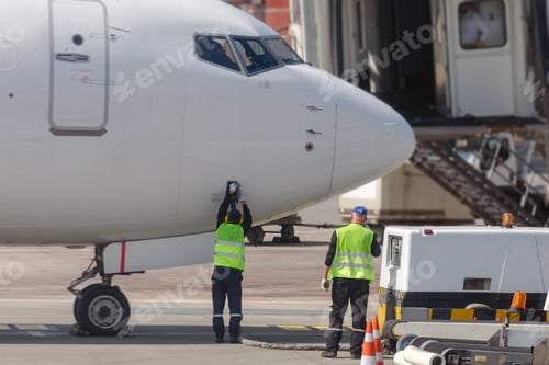 Preview: Airport ground staff check the plane