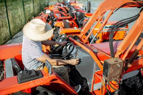Preview: Agronomist choosing tractor at the agricultural shop