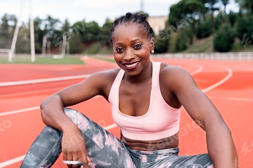 Preview: Athlete sprinter sitting on the athletics track