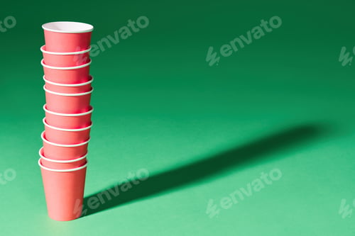 Preview: Stack of red paper cup on green background