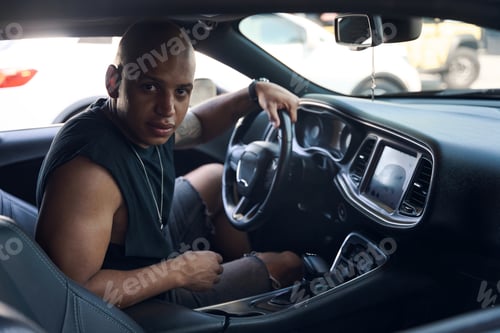 Preview: Man sitting on driver seat of new modern car with on-board computer