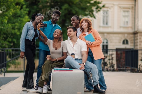 Preview: Group of diverse college classmates taking selfie at university campus