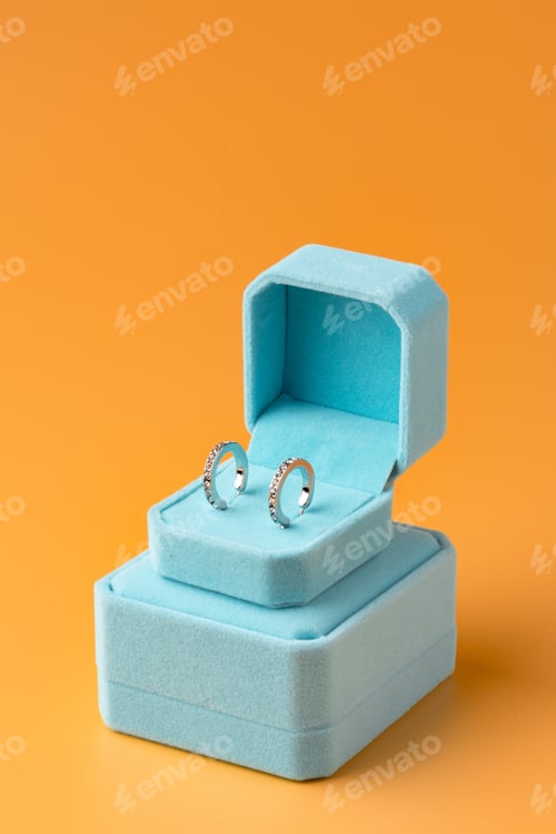 Preview: Blue jewelry box on yellow background close up