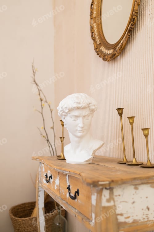 Preview: David's head sculpture on the table in living room. Home interior decor room for art.